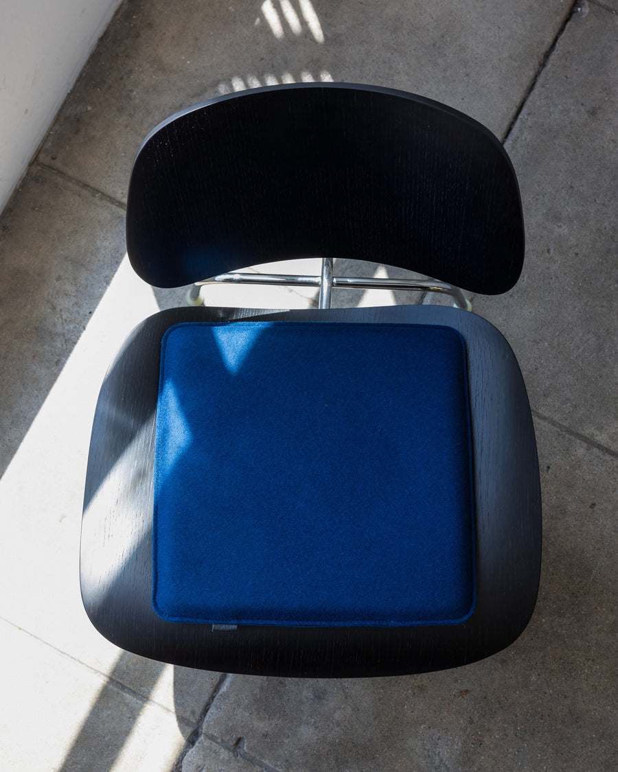 Zabuton Merino Wool Square Seat Pad in Marine on a black chair, view from above