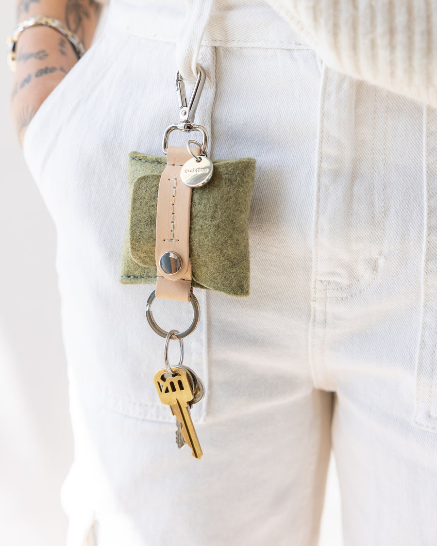 The Pod Fob holds your keys and pods. Here in sage color