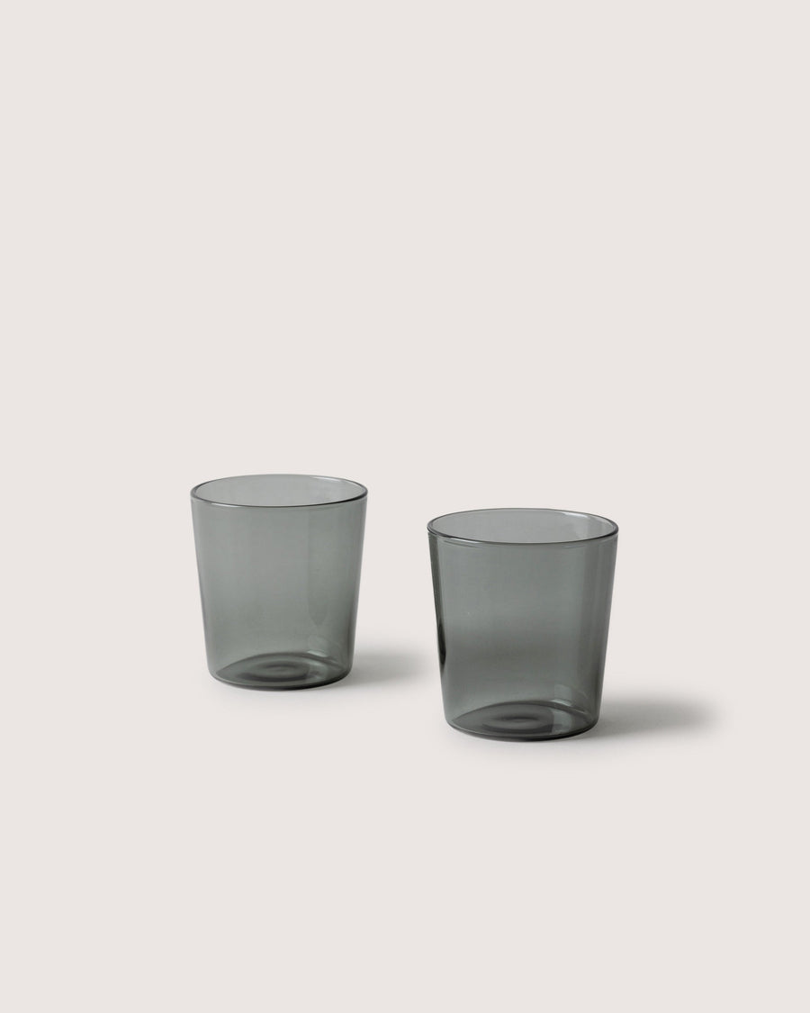 Two small Glas Tumbler in color smoke, white background