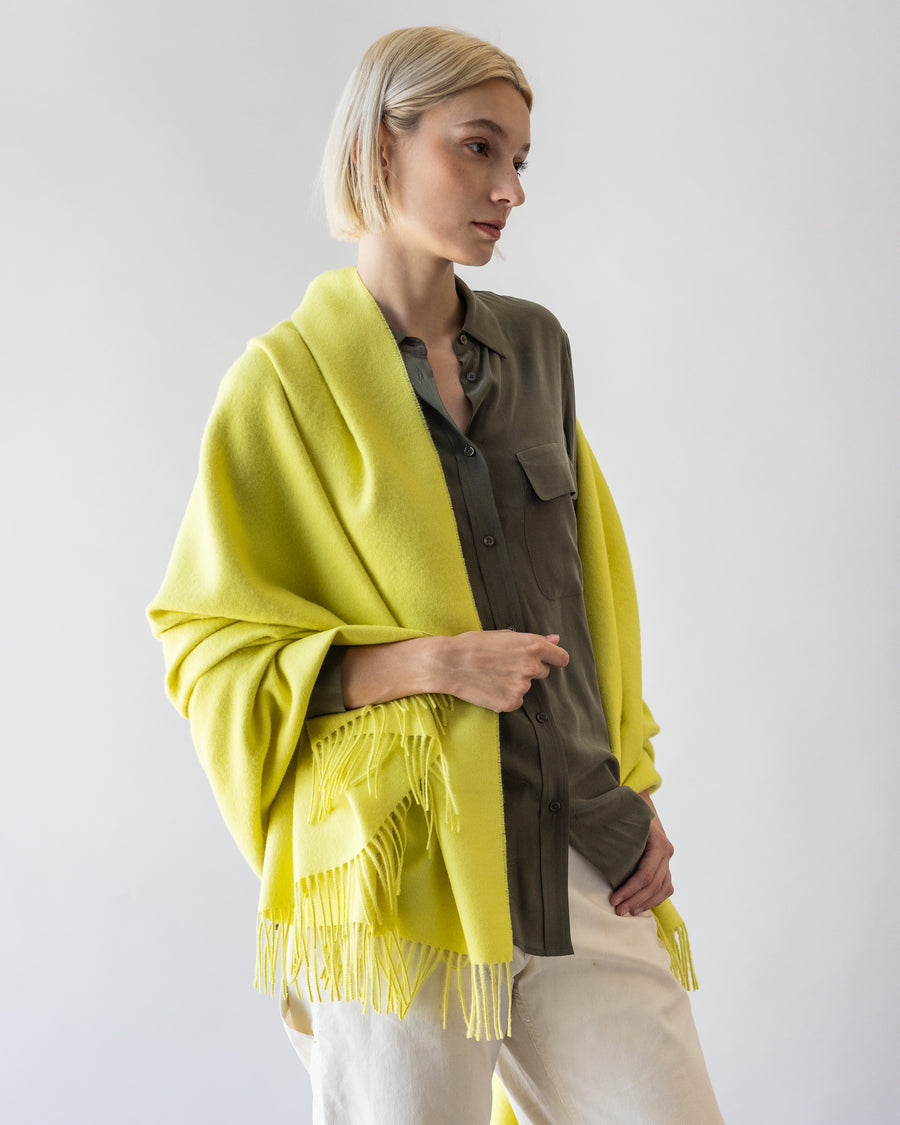 Blonde woman with a citron colored alpaca throw by Graf Lantz over her right shoulder