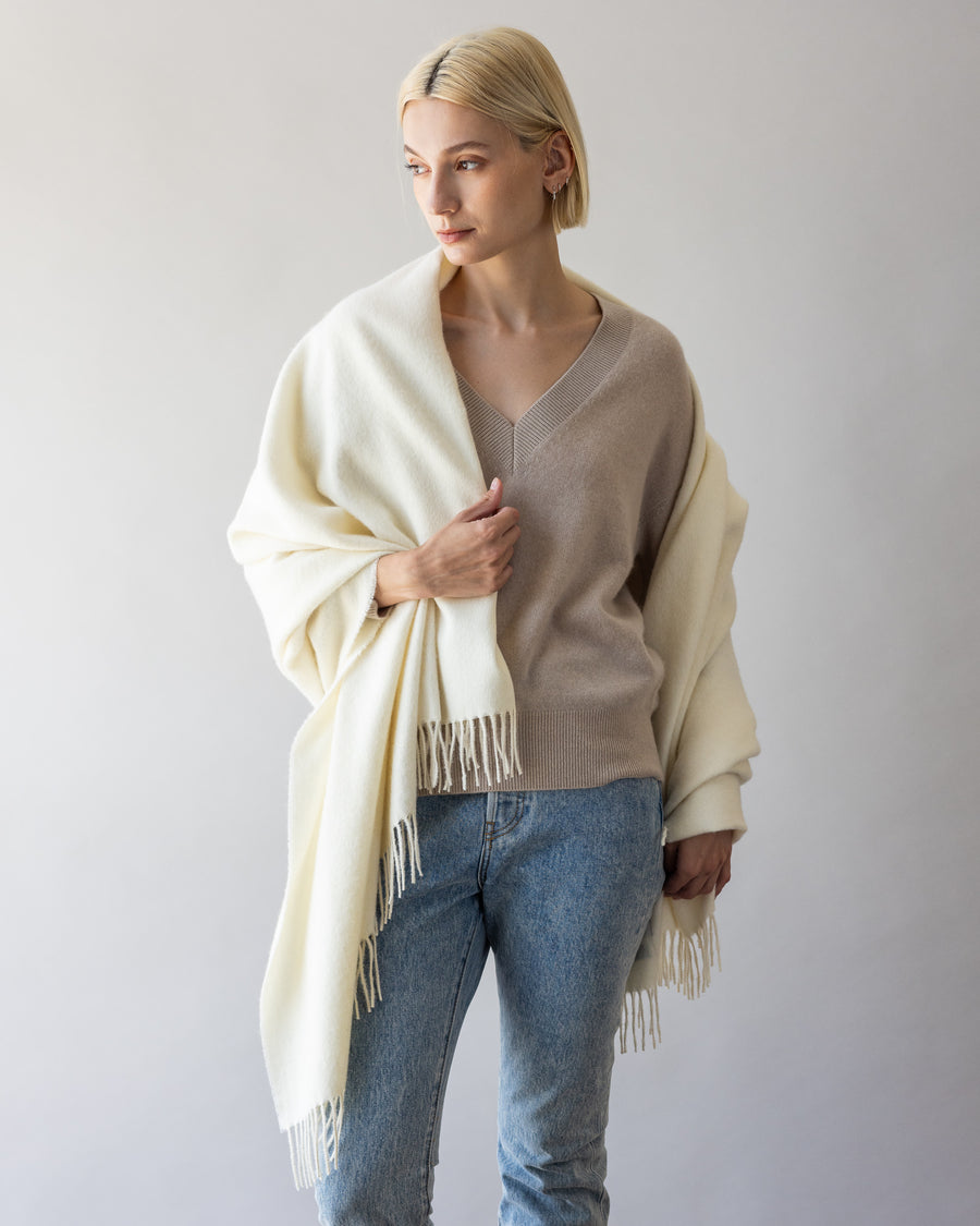 Blonde woman with a white alpaca throw by Graf Lantz over her right shoulder